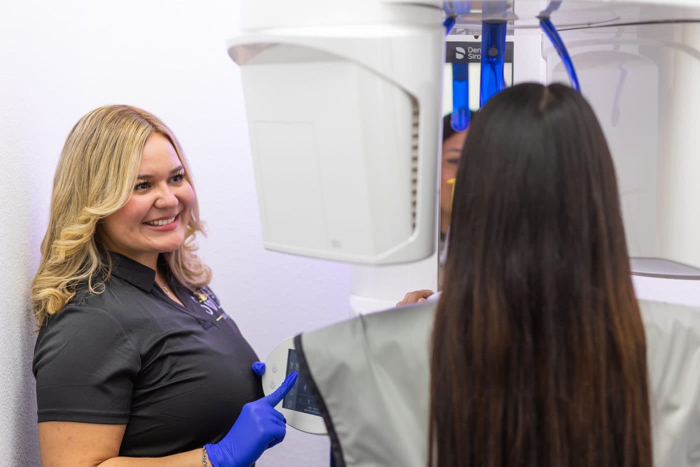 A Soleil Dental Mesquite team member positioning a patient in the 3D scanner