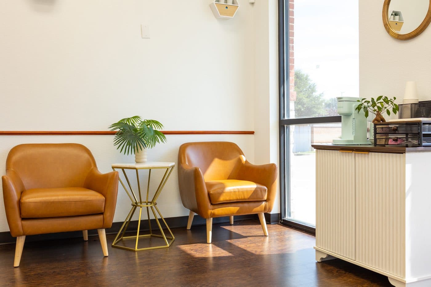 The quiet Soleil Dental Mesquite waiting room with leather chairs by a big window