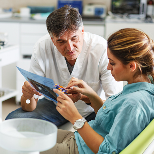Dentist talking to a patient about Aetna dental insurance in Mesquite