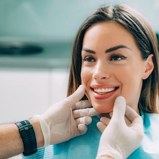 Woman smiling at her cosmetic dentist in Mesquite after treatment