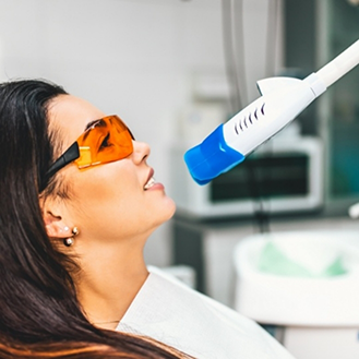 Woman in the dental chair getting her teeth professionally whitened