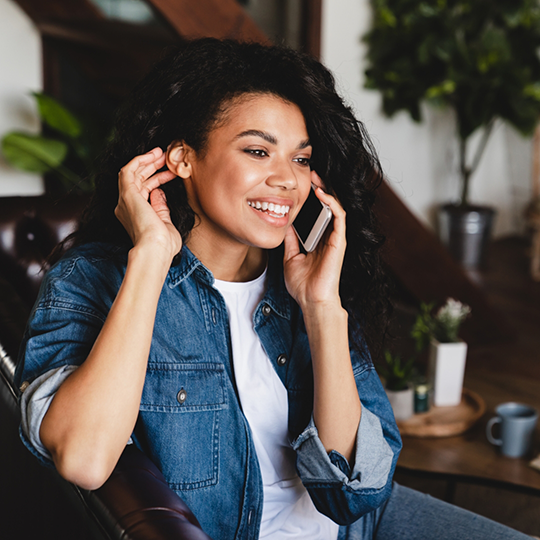 Woman smiling while talking on the phone about dental insurance in Mesquite