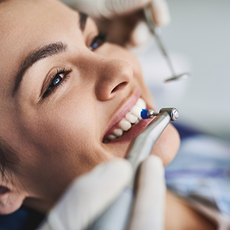 CLose up of a woman receiving a teeth cleaning