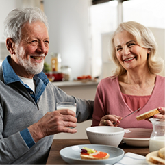 Senior couple eating a meal together at home