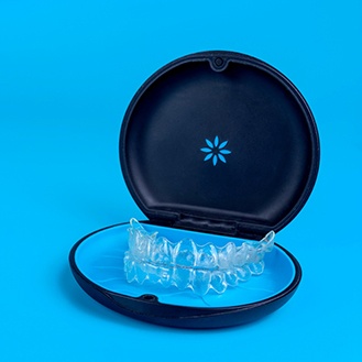 Invisalign trays in carrier case with blue background