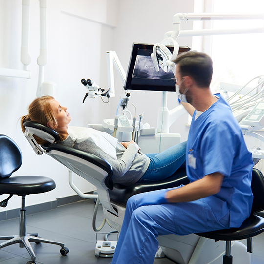 Dentist talking to a patient during their dental checkup