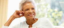 Smiling older woman resting her chin on her hand