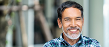 Smiling man in a blue plaid shirt