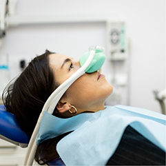 Dental patient with a nitrous oxide mask over her nose
